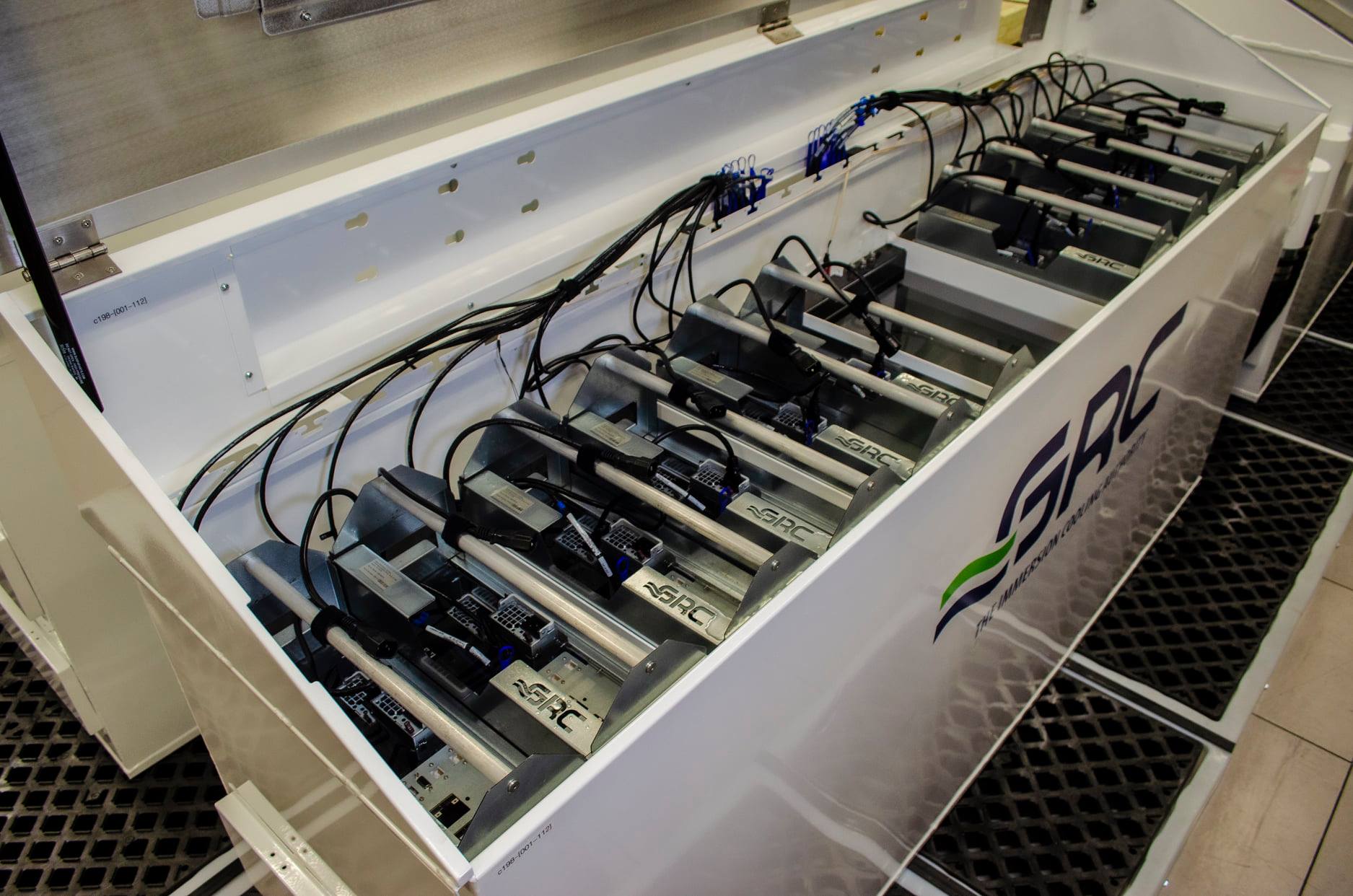 View down into a bank of liquid-immersed servers, each of which hosts 4 NVIDIA Quadro RTX 5000 GPUs.